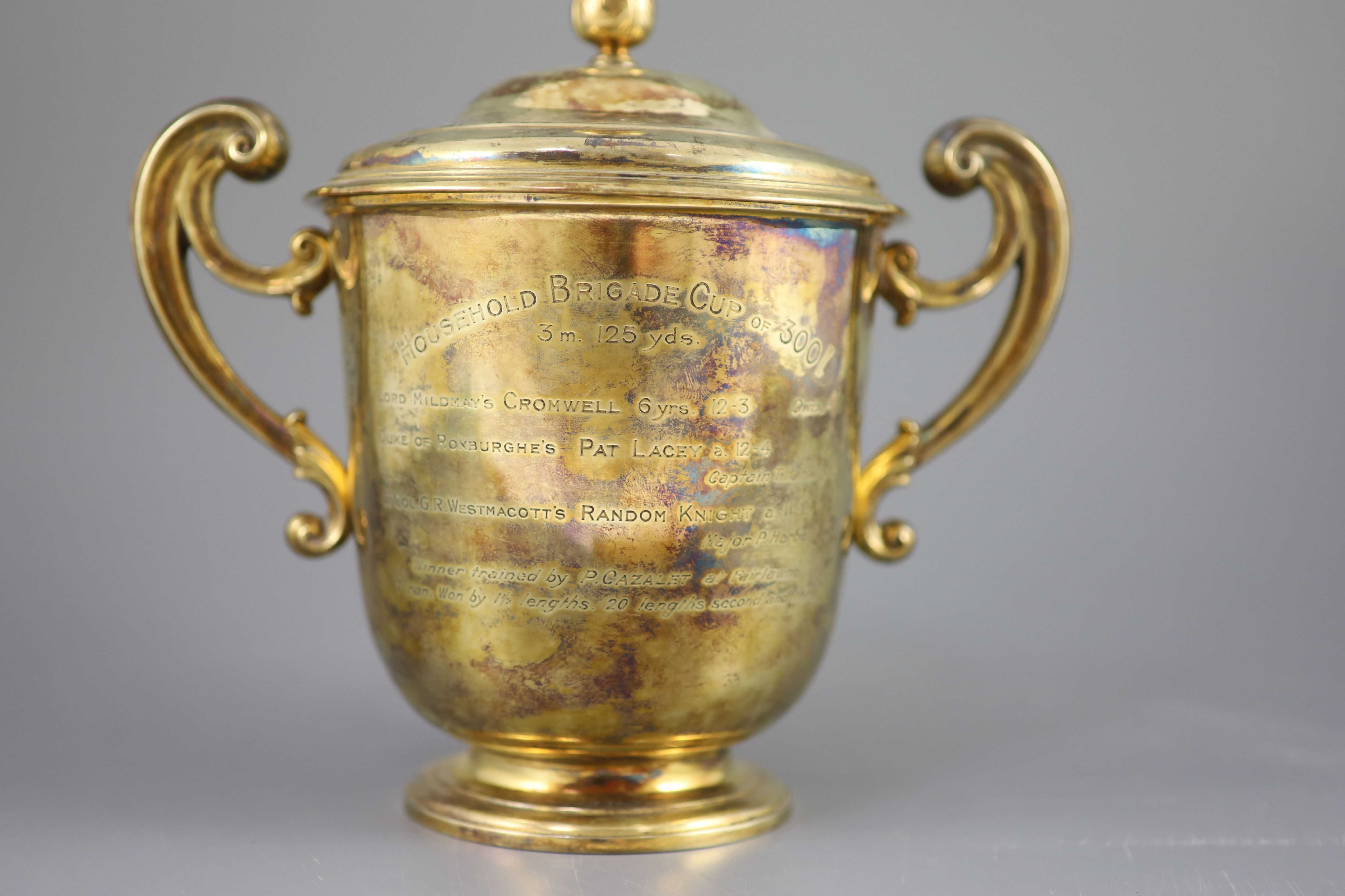 An Edwardian silver gilt-lidded two handled presentation cup and cover, by R & S Garrard and Co.